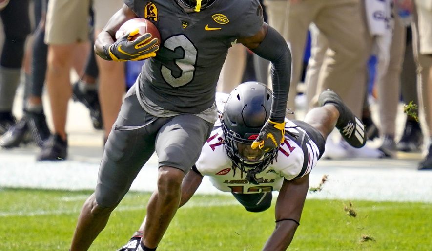 Pittsburgh wide receiver Jordan Addison (3) gets past a diving Louisville linebacker Dorian Etheridge (17) during the first half of an NCAA college football game, Saturday, Sept. 26, 2020, in Pittsburgh. (AP Photo/Keith Srakocic)