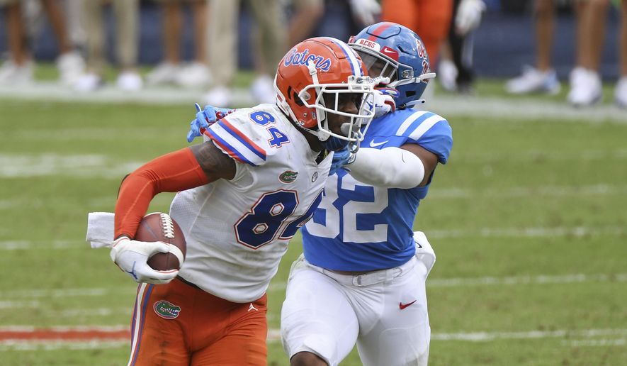 Florida tight end Kyle Pitts (84) breaks away from Mississippi linebacker Jacquez Jones (32) during the second half of an NCAA college football game in Oxford, Miss., Saturday, Sept. 26, 2020. No. 5 Florida won 51-35. (AP Photo/Thomas Graning)