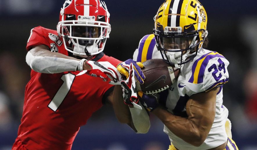 FILE - In this Dec. 7, 2019, file photo, LSU cornerback Derek Stingley Jr. (24) intercepts the ball from Georgia wide receiver George Pickens (1) during the second half of the Southeastern Conference championship NCAA college football game, in Atlanta. LSU says Stingley Jr. has been ruled out of the No. 6 Tigers’ opener Saturday, Sept. 26, 2020 against Mississippi State because of an illness. LSU spokesman Michael Bonnette says Stingley’s illness is not COVID-19 and that the sophomore is expected to rejoin football activities after concluding medical treatment evaluation by doctors. (AP Photo/John Bazemore, File)