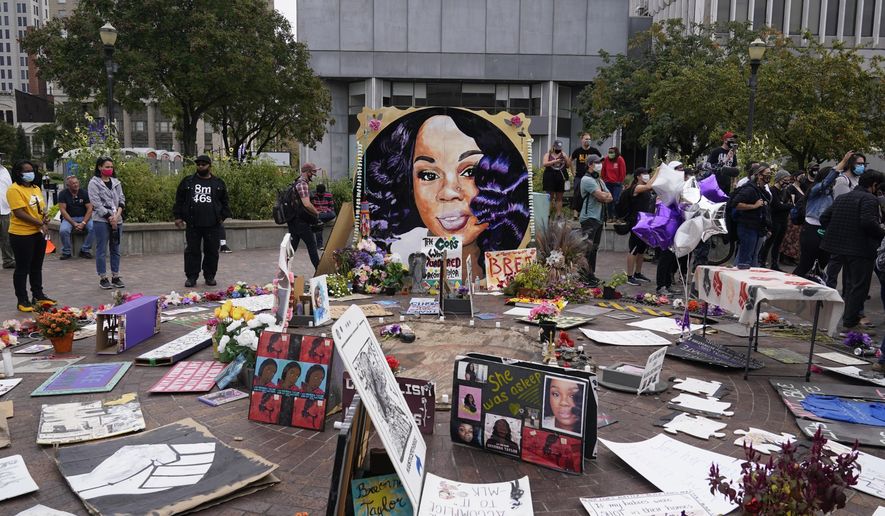 In this Wednesday, Sept. 23, 2020, file photo, people gather in Jefferson Square in Louisville, awaiting word on charges against police officers in the death of Breonna Taylor. (AP Photo/Darron Cummings, File)
