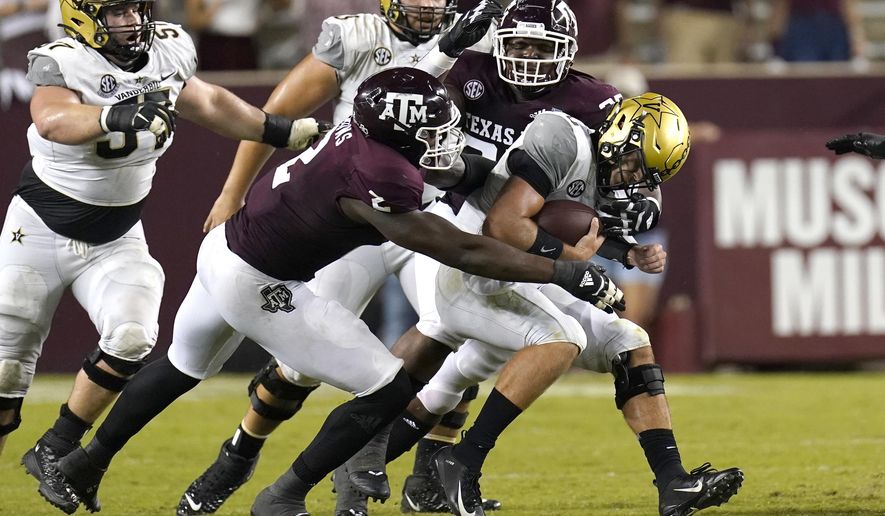 Vanderbilt quarterback Ken Seals, right, is sacked by Texas A&M's Micheal Clemons (2) McKinnley Jackson during the second half of an NCAA college football game Saturday, Sept. 26, 2020, in College Station, Texas. Texas A&M won 17-12. (AP Photo/David J. Phillip)