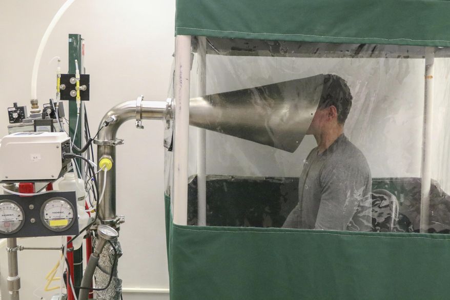 This February 2018 photo provided by the University of Maryland School of Public Health shows The Gesundheit II machine in Dr. Donald Milton's Public Health Aerobiology, Virology, and Exhaled Biomarker Laboratory of the university in College Park, Md. The device is helping scientists study a big question: Just how does the virus that causes COVID-19 spread from one person to another? (University of Maryland School of Public Health via AP)