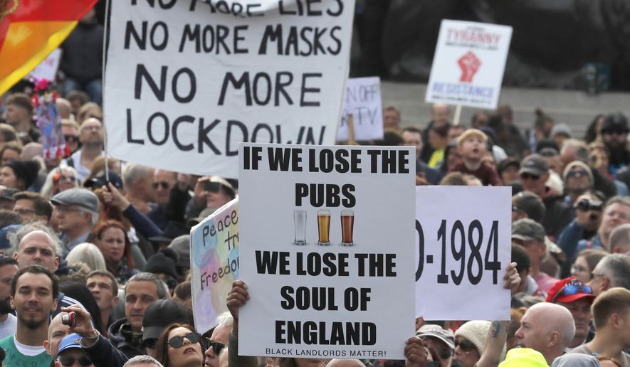 People take part in a 'We Do Not Consent' rally at Trafalgar Square, organised by Stop New Normal, to protest against coronavirus restrictions, in London, Saturday, Sept. 26, 2020. (AP Photo/Frank Augstein)