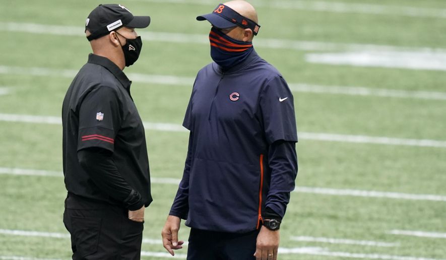 Chicago Bears head coach Matt Nagy and Atlanta Falcons head coach Dan Quinn speak at midfield before the first half of an NFL football game, Sunday, Sept. 27, 2020, in Atlanta. (AP Photo/Brynn Anderson)