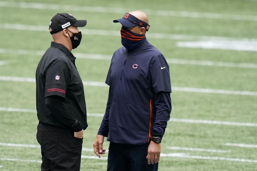 Chicago Bears head coach Matt Nagy and Atlanta Falcons head coach Dan Quinn speak at midfield before the first half of an NFL football game, Sunday, Sept. 27, 2020, in Atlanta. (AP Photo/Brynn Anderson)