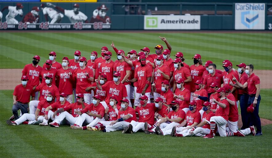 Members of the St. Louis Cardinals celebrate after defeating the Milwaukee Brewers in a baseball game to earn a playoff birth Sunday, Sept. 27, 2020, in St. Louis. (AP Photo/Jeff Roberson)
