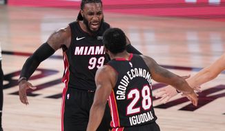 Miami Heat&#39;s Jae Crowder (99) and teammate Andre Iguodala (28) celebrate a basket during the second half of an NBA conference final playoff basketball game against the Boston Celtics Sunday, Sept. 27, 2020, in Lake Buena Vista, Fla. (AP Photo/Mark J. Terrill)