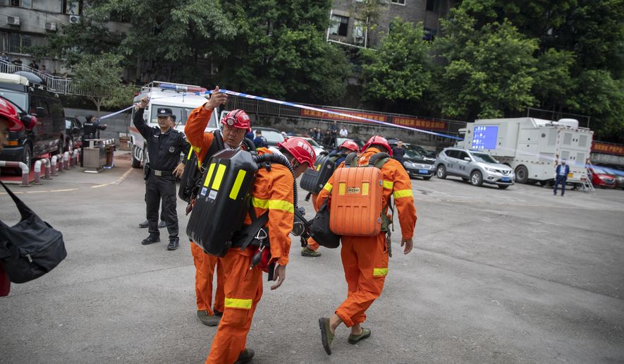 In this photo provided by China&#x27;s Xinhua News Agency, rescuers arrive at a coal mine in southwest China&#x27;s Chongqing Municipality, Sunday, Sept. 27, 2020. More than a dozen of people died Sunday in the coal mine in southwestern China because of excessively high levels of carbon monoxide, authorities and state media said. (Huang Wei/Xinhua via AP)