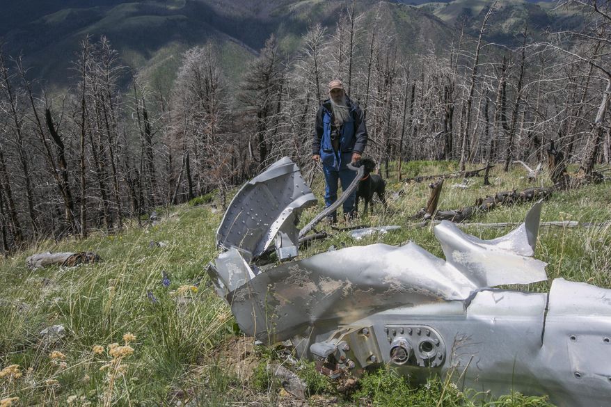 FILE - This June 2016, file photo shows wreckage from a U.S. Air Force that bomber crashed on Emigrant Peak in southwestern Montana on July 23, 1962, killing four men during a training run. The wreckage still remains on a remote section of the peak. Emigrant, Montana resident Bryan Wells, has succeeded in his efforts to create a memorial for the men who died. The U.S. House of Representatives on Sept. 21, 2020, passed a bill naming the crash site as "B-47 Ridge." The U.S. Senate has already passed the bill and it is awaiting the signature of President Donald Trump.(Adrian Sanchez-Gonzalez/Bozeman Daily Chronicle via AP, FILE)