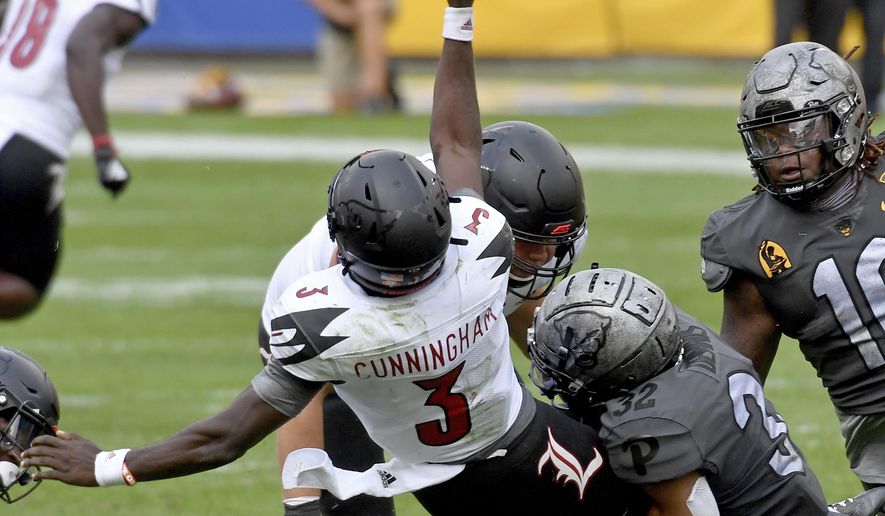 Pittsburgh linebacker SirVocea Dennis takes down Louisville quarterback Malik Cunningham as he gets a pass off in the fourth quarter during an NCAA college football game at Heinz Field, Saturday, Sept. 26, 2020, in Pittsburgh. (Matt Freed/Pittsburgh Post-Gazette via AP)