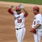 Washington Nationals&#x27; Juan Soto (22) reacts at first after his single during the second inning of a baseball game against the New York Mets, Sunday, Sept. 27, 2020, in Washington. Nationals first base coach Bob Henley, right. (AP Photo/Nick Wass)