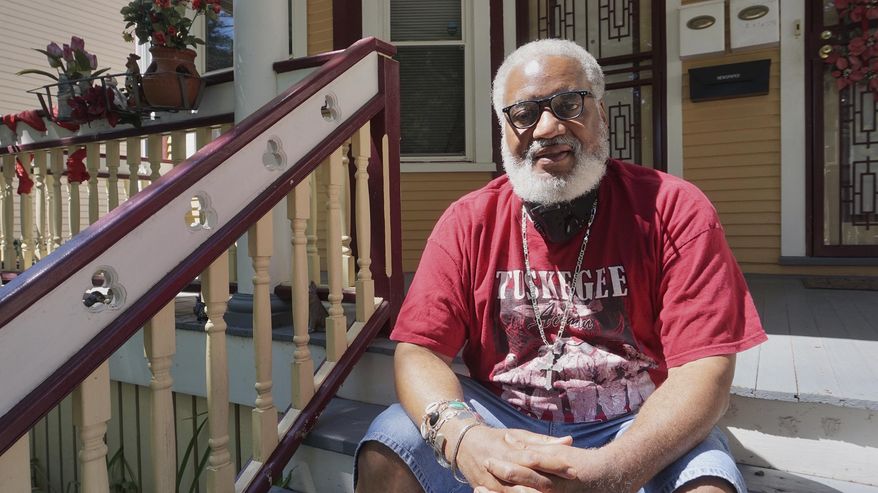Pastor Greg Lewis, founder and president of Souls to the Polls and Pastors United, poses for a photo Aug.7, 2020 in Milwaukee. He survived coronavirus, and now, he's back to organizing for change. (Photo by Bridget Fogarty/Milwaukee Neighborhood News Service via AP)