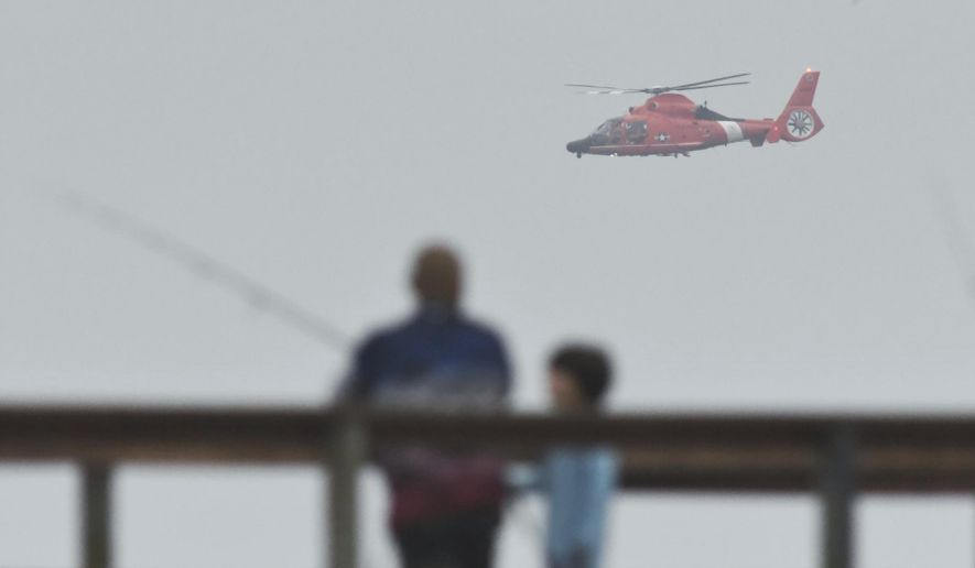 In this file photo, a U.S. Coast Guard helicopter searches the coastline for a small plane that may have crashed in Santa Barbara, Calif., Sunday, Sept. 27, 2020. (Mike Eliason/Santa Barbara County Fire via AP) **FILE**