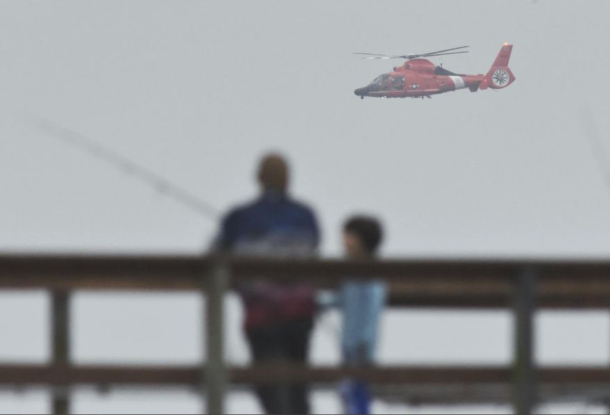 In this file photo, a U.S. Coast Guard helicopter searches the coastline for a small plane that may have crashed in Santa Barbara, Calif., Sunday, Sept. 27, 2020. (Mike Eliason/Santa Barbara County Fire via AP) **FILE**
