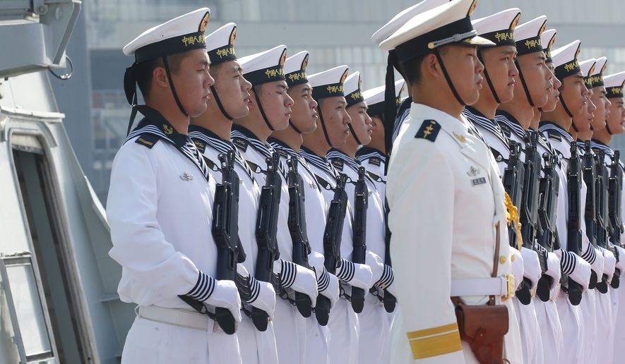In this Jan. 17, 2019, file photo, Chinese People's Liberation Navy sailors stand in formation on the deck of a type 054A guided missile frigate "Wuhu" as it docks at Manila's South Harbor for a four-day port call in Manila, Philippines. (AP Photo/Bullit Marquez) **FILE**