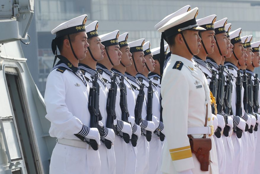 In this Jan. 17, 2019, file photo, Chinese People's Liberation Navy sailors stand in formation on the deck of a type 054A guided missile frigate "Wuhu" as it docks at Manila's South Harbor for a four-day port call in Manila, Philippines. (AP Photo/Bullit Marquez) **FILE**