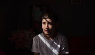 Bawi UK, 22, is photographed in his apartment in Providence, R.I., Saturday, Sept. 26, 2020. UK was a small child when his parents fled Myanmar, leaving him and his siblings to be cared for by their maternal grandmother. UK said the family suffered discrimination as Christians in a predominantly Buddhist nation. The military government was also trying to forcibly conscript his father. &amp;quot;To run for office, you had to be a Buddhist; to rent a house, you had to be Buddhist,&amp;quot; said UK, a social work student at Rhode Island College and a youth leader at the Refugee Dream Center, an advocacy organization in Providence. (AP Photo/David Goldman)