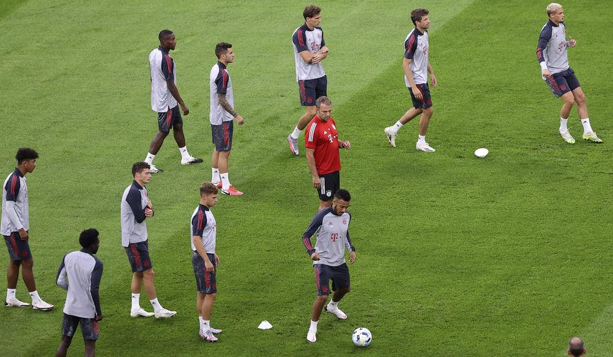 Bayern head coach Hansi Flick instructs his team during a training session the day before the UEFA Super Cup soccer match between Bayern Munich and Sevilla at the Puskas Arena in Budapest, Hungary, Wednesday, Sept. 23, 2020. (Laszlo Szirtesi/Pool via AP)