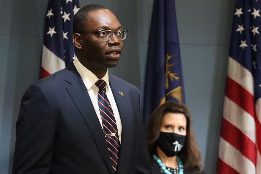 FILE - In this Sept. 10, 2020, file photo, provided by the Michigan Office of the Governor, Michigan Lt. Gov. Garlin Gilchrist II, accompanied by Gov. Gretchen Whitmer, right, speaks during an address to the state in Lansing, Mich. Michigan reported Monday, Sept. 28, 2020 that Black residents are no longer being disproportionately infected and killed by the coronavirus, after they accounted for a staggering 40% of deaths and 29% of cases in the early days of the pandemic. Gilchrist credits people of color for being more likely to wear masks and follow safety guidelines. (Michigan Office of the Governor via AP File)