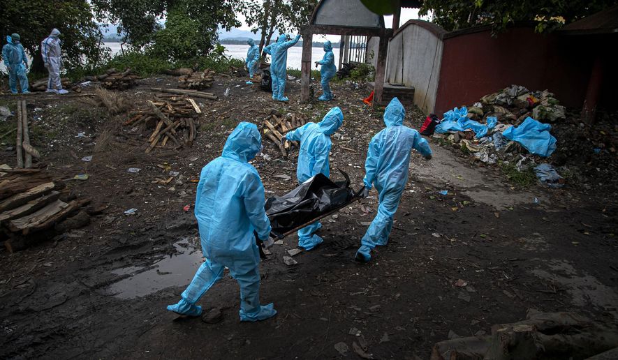 Health workers wearing personal protective equipment carry the body of a COVID-19 victim for cremation in Gauhati, India, Thursday, Sept. 10, 2020. (AP Photo/Anupam Nath)
