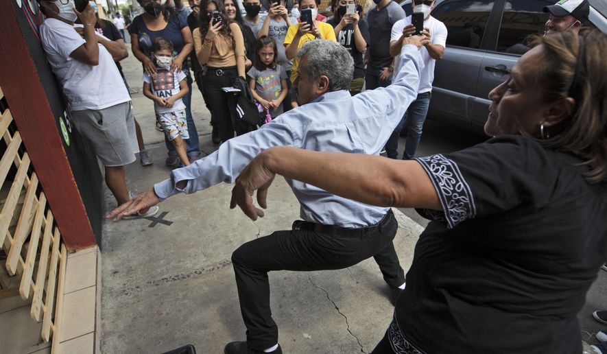 Fabio Rodolfo Vasquez and his wife, Maria Moreno, dance at a promotional event outside a coffee shop on the outskirts of Guatemala City, Saturday, Sept. 19, 2020. The couple met in a Guatemala City club more than 30 years ago when they won a dance contest. (AP Photo/Moises Castillo)