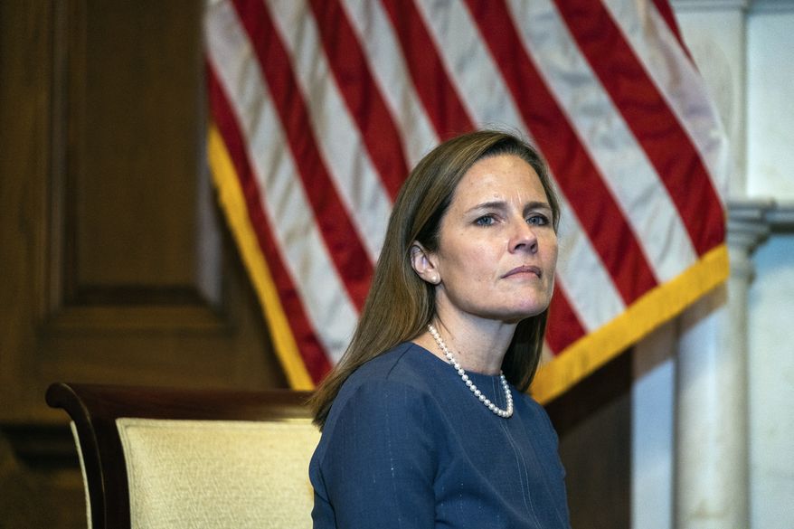 Judge Amy Coney Barrett, President Donald Trumps nominee for the U.S. Supreme Court, meets with Sen. Sen. Lindsey Graham, R-S.C., on Capitol Hill in Washington, Tuesday, Sept. 29, 2020. (Demetrius Freeman/Pool via AP)