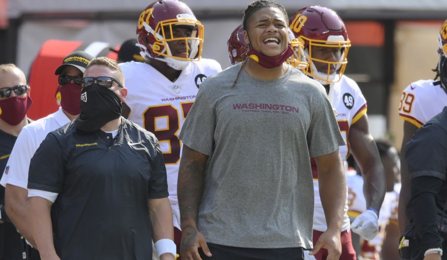 Washington Football Team defensive end Chase Young stands on the sideline during an NFL football game against the Cleveland Browns, Sunday, Sept. 27, 2020, in Cleveland. The Browns won 34-20. (AP Photo/David Richard)