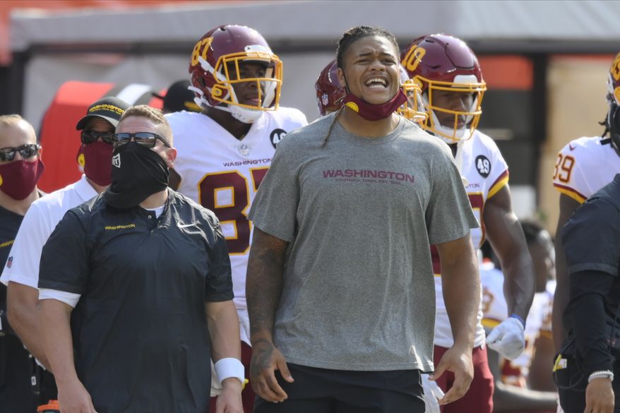 Washington Football Team defensive end Chase Young stands on the sideline during an NFL football game against the Cleveland Browns, Sunday, Sept. 27, 2020, in Cleveland. The Browns won 34-20. (AP Photo/David Richard)