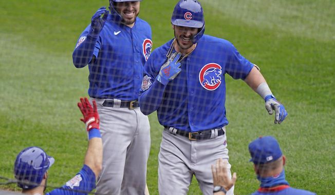 Chicago Cubs&#x27; Kris Bryant, top right, is congratulated by teammates after hitting a solo home run during the second inning of a baseball game against the Chicago White Sox in Chicago, Sunday, Sept. 27, 2020. (AP Photo/Nam Y. Huh)