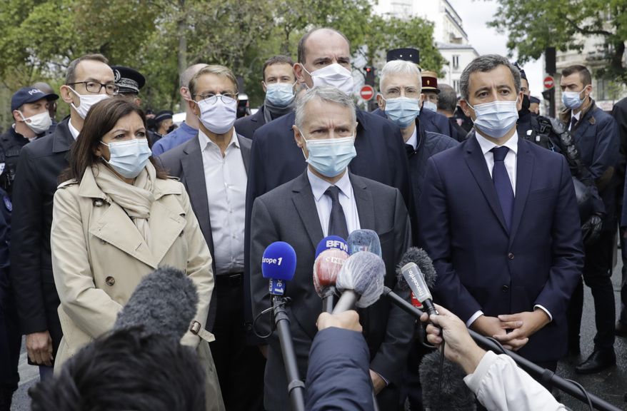 From the left, Paris mayor Anne Hidalgo, anti-terrorism state prosecutor Jean-Francois Ricard , and Interior Minister Gerald Darmanin answer reporters after a knife attack near the former offices of satirical newspaper Charlie Hebdo, Friday Sept. 25, 2020 in Paris. French terrorism authorities are investigating a stabbing of two people outside the former offices of the satirical newspaper Charlie Hebdo in Paris, and two suspects have been arrested, authorities said. (AP Photo/Lewis Joly)