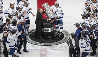 Tampa Bay Lightning&#39;s Steven Stamkos (91) is presented the Stanley Cup from NHL commissioner Gary Bettman as they celebrate after defeating the Dallas Stars in the NHL Stanley Cup hockey finals, in Edmonton, Alberta, on Monday, Sept. 28, 2020. (Jason Franson/The Canadian Press via AP)