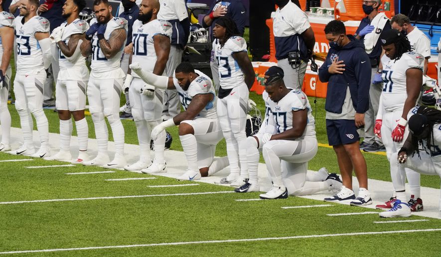Members of the Tennessee Titans take part in the national anthem before an NFL football game against the Minnesota Vikings, Sunday, Sept. 27, 2020, in Minneapolis. The NFL says the Tennessee Titans and Minnesota Vikings are suspending in-person activities after the Titans had three players test positive for the coronavirus, along with five other personnel. The league says both clubs are working closely with the NFL and the players’ union on tracing contacts, more testing and monitoring developments. The Titans are scheduled to host the Pittsburgh Steelers on Sunday.(AP Photo/Jim Mone)
