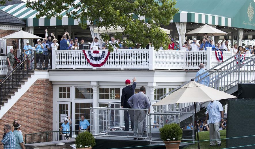 FILE - In this July 15, 2017 file photo, President Donald Trump turns to wave to people gathered at the clubhouse as his walks to his presidential viewing stand during the U.S. Women&#39;s Open Golf tournament at Trump National Golf Club in Bedminster, N.J. Trump’s true financial picture has gotten renewed scrutiny in the wake of a New York Times report in September 2020 that he declared hundreds of millions in losses in recent years, allowing him to pay just $750 in taxes the year he won the presidency, and nothing for 10 of 15 years before that. (AP Photo/Carolyn Kaster, File)