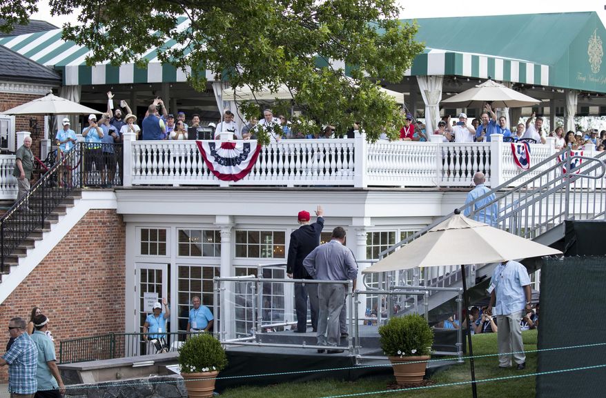 FILE - In this July 15, 2017 file photo, President Donald Trump turns to wave to people gathered at the clubhouse as his walks to his presidential viewing stand during the U.S. Women&#39;s Open Golf tournament at Trump National Golf Club in Bedminster, N.J. Trump’s true financial picture has gotten renewed scrutiny in the wake of a New York Times report in September 2020 that he declared hundreds of millions in losses in recent years, allowing him to pay just $750 in taxes the year he won the presidency, and nothing for 10 of 15 years before that. (AP Photo/Carolyn Kaster, File)