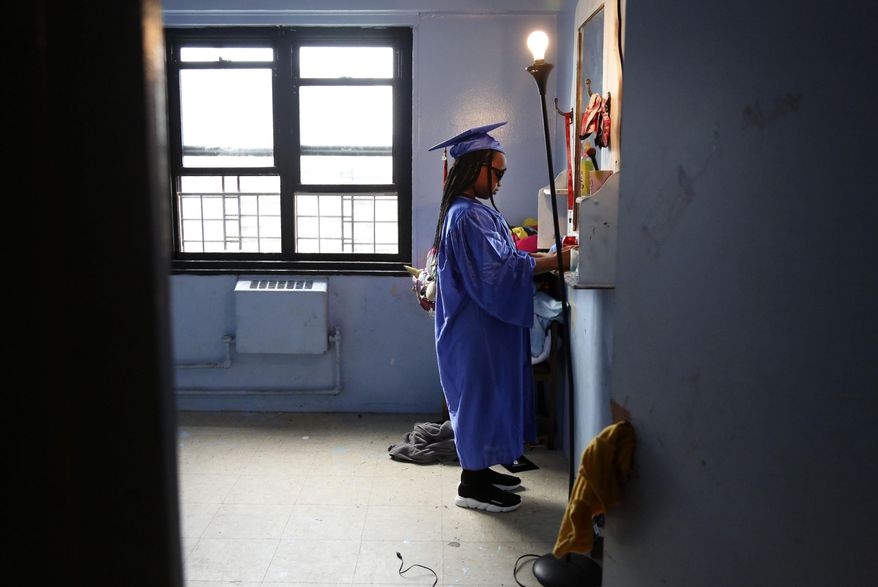 FILE - In this Friday, Aug. 21, 2020, file photo, Maddison Washington, 11, stands at her bedroom mirror as she gets ready for her virtual graduation from her Brooklyn middle school, in the Brooklyn borough of New York. After being delayed twice, hundreds of thousands of elementary school students are heading back to classrooms Tuesday, Sept. 29 as New York City enters a high-stakes phase of resuming in-person learning during the coronavirus pandemic. (AP Photo/Jessie Wardarski, File)