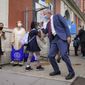 New York Mayor Bill de Blasio, center right, greets students as they arrive for in-person classes outside Public School 188 The Island School, Tuesday, Sept. 29, 2020, in the Manhattan borough of New York. Hundreds of thousands of elementary school students are heading back to classrooms starting Tuesday as New York City enters a high-stakes phase of resuming in-person learning during the coronavirus pandemic. (AP Photo/John Minchillo)