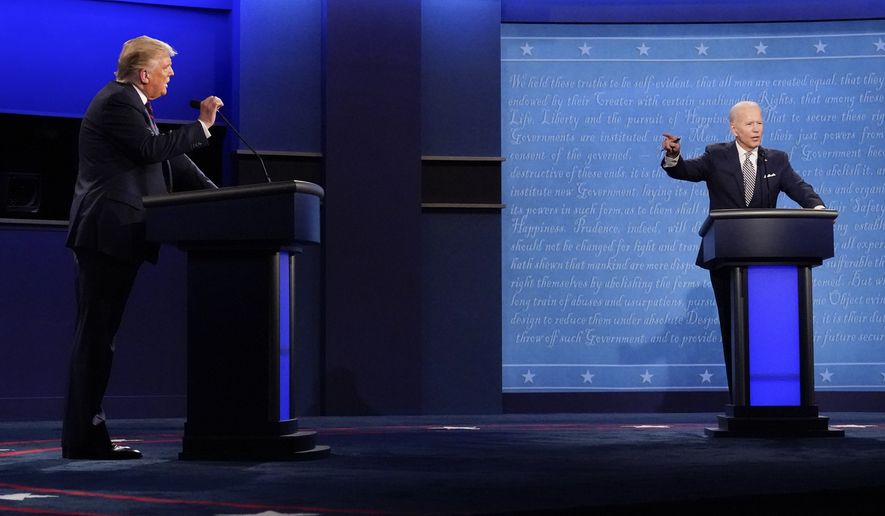 President Donald Trump, left, and Democratic presidential candidate former Vice President Joe Biden, right, gesturing during the first presidential debate Tuesday, Sept. 29, 2020, at Case Western University and Cleveland Clinic, in Cleveland, Ohio. (AP Photo/Julio Cortez)