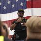 Proud Boys leader Enrique Tarrio speaks to supporters at a rally in Delta Park on Saturday, Sept. 26, 2020, in Portland, Ore. (AP Photo/Allison Dinner)