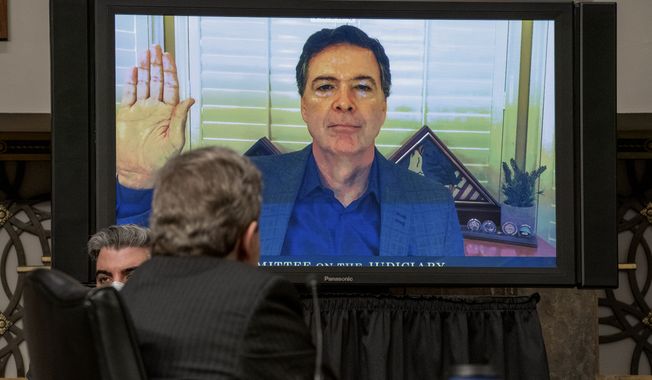 Former FBI Director James Comey is sworn via videoconference before testifying during a Senate Judiciary Committee hearing on Capitol Hill in Washington, Wednesday, Sept. 30, 2020, to examine the FBI &quot;Crossfire Hurricane&quot; investigation. (Ken Cedeno/Pool via AP)