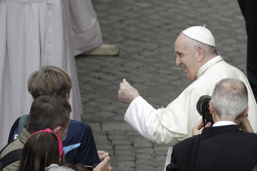 Pope Francis greets faithful during his weekly general audience in the St. Damaso courtyard at the Vatican, Wednesday, Sept. 30, 2020. (AP Photo/Gregorio Borgia)