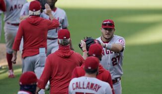 Los Angeles Angels center fielder Mike Trout, right, celebrates with teammates after the Angels defeated the San Diego Padres in a baseball game Wednesday, Sept. 23, 2020, in San Diego. (AP Photo/Gregory Bull)