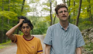 This image released by Bleecker Street shows Sunita Mani, left, and John Reynolds in a scene from &amp;quot;Save Yourselves!&amp;quot; (Bleecker Street via AP)