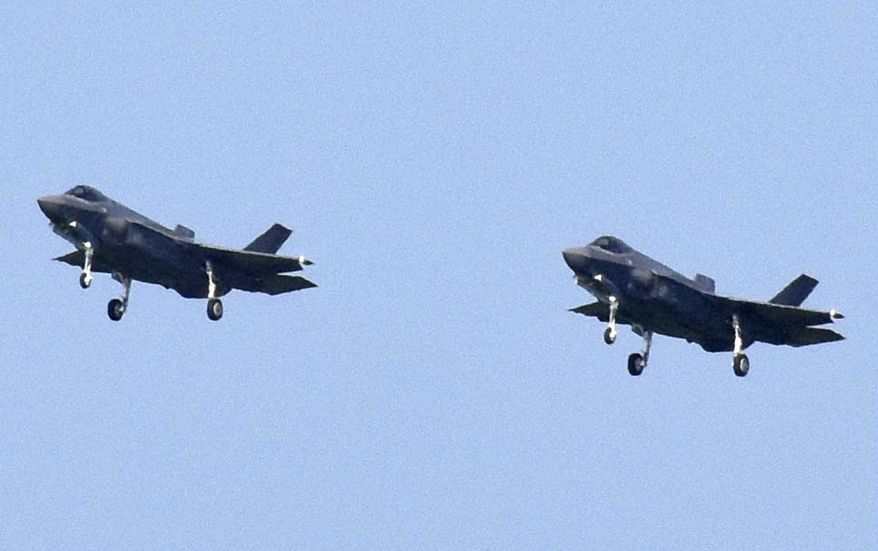 In this Aug. 1, 2019, file photo, Japanese Air Self-Defense Force's F-35A stealth fighter jets prepare to land at Misawa Air Base in Misawa, northern Japan. Japan's Defense Ministry is seeking a record-high budget of nearly 5.5 trillion yen ($55 billion) for fiscal 2021 fund more purchases of costly American stealth fighters and expand its capability to counter possible threats in both cyber and outer space.(Kyodo News via AP, File)