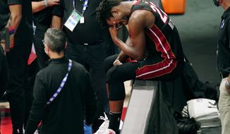 Miami Heat&#39;s Jimmy Butler (22) pauses after an apparent injury during the first half of Game 1 of basketball&#39;s NBA Finals Wednesday, Sept. 30, 2020, in Lake Buena Vista, Fla. (AP Photo/Mark J. Terrill)