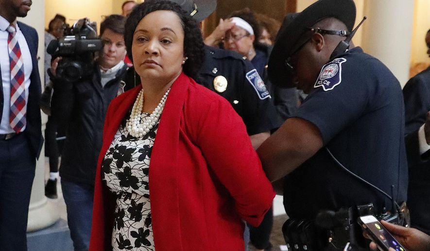 Sen. Nikema Williams (D-Atlanta) is arrested by capitol police in the rotunda of the state capitol building in Atlanta. The Georgia state lawmaker and nine others arrested while protesting at the state Capitol in the wake of the 2018 midterm elections have filed a lawsuit seeking to prohibit further enforcement of the law cited in their arrest. Williams was among 15 people arrested in November 2018 while calling for uncounted ballots to be tallied. The federal lawsuit filed Tuesday, Sept. 30, 2020 against a dozen Department of Public Safety officers says the law in question is unconstitutional and overly broad. (AP Photo/John Bazemore, file)