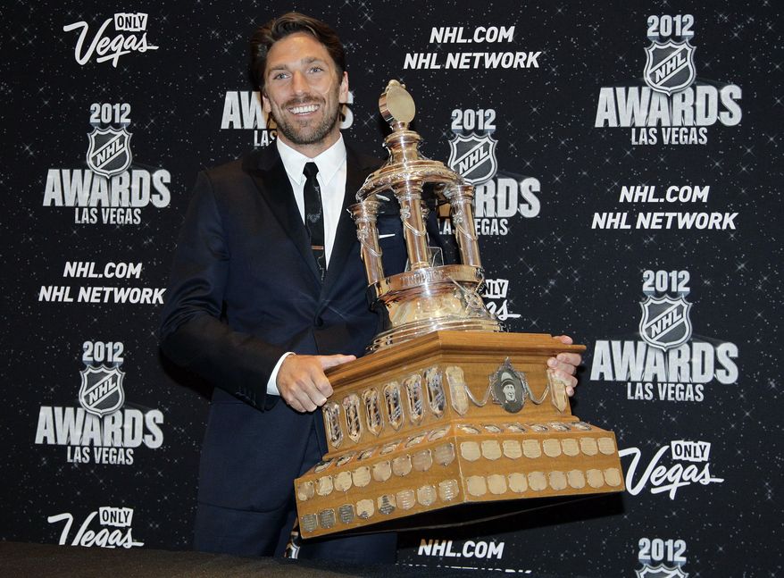 FILE - In this June 20, 2012, file photo, New York Rangers&#39; Henrik Lundqvist poses with the Vezina Trophy after winning the award for the league&#39;s best goalie during the NHL Awards in Las Vegas. The New York Rangers have bought out the contract of star goaltender Henrik Lundqvist. The Rangers parted with one of the greatest netminders in franchise history on Wednesday, Sept. 30, 2020, when they paid off the final year of his contract.(AP Photo/Julie Jacobson, File)