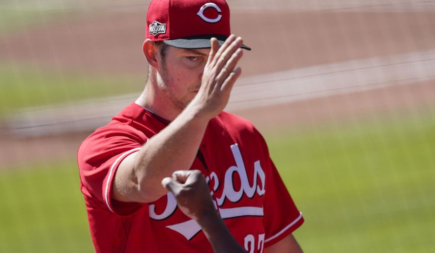 Cincinnati Reds starting pitcher Trevor Bauer (27) leaves the game in the eighth against the Atlanta Braves during Game 1 of a National League wild-card baseball series, Wednesday, Sept. 30, 2020, in Atlanta. (AP Photo/John Bazemore)