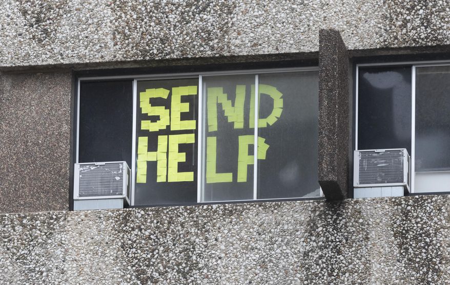 A message is shown in a window at Sellery Residence Hall on the University of Wisconsin in Madison, Wis. campus, citing rapidly rising COVID-19 cases, in this Sept. 10, 2020, file photo. Gov. Tony Evers is urging people throughout Wisconsin to "get on the same team" and take steps to slow the spread of the coronavirus, as cases continue to soar at the state's highest levels since the pandemic began. (Mark Hoffmann/Milwaukee Journal-Sentinel via AP, File)