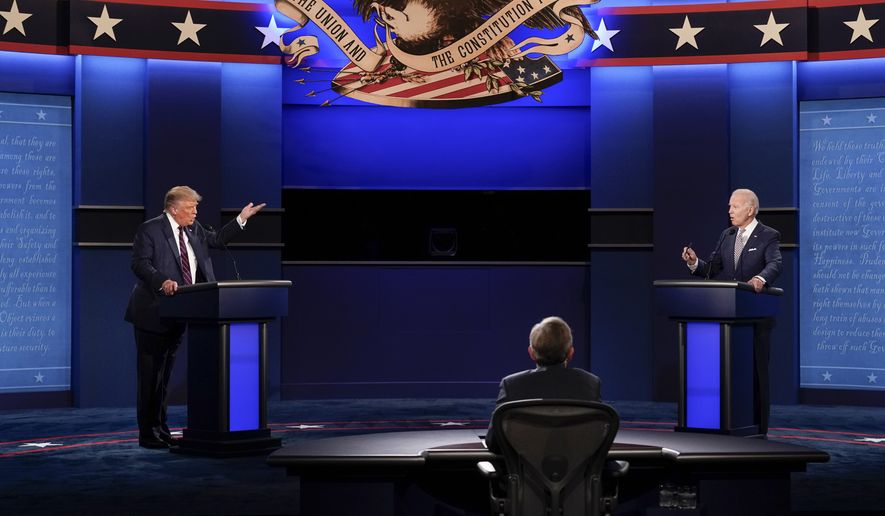 President Donald Trump, left, and Democratic presidential candidate former Vice President Joe Biden, right, during the first presidential debate Tuesday, Sept. 29, 2020, at Case Western University and Cleveland Clinic, in Cleveland, Ohio. Seated in the center is moderator Chris Wallace of Fox News. (AP Photo/Patrick Semansky)