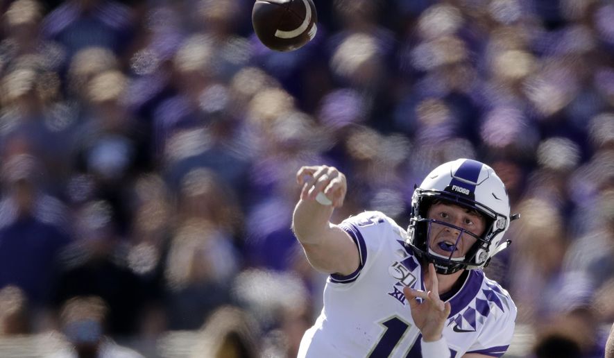 FILE - In this Oct. 19, 2019, file photo, TCU quarterback Max Duggan passes during the first half of an NCAA college football game against Kansas State in Manhattan, Kan. Duggan and Alan Bowman have come back throwing strong again in the Big 12 after both experienced different health issues. Duggan never had any symptoms or problems from a previously undetected lifelong heart issue that was not discovered until the TCU quarterback was going through enhanced COVID-19 protocols as part of preseason testing. (AP Photo/Charlie Riedel, File)